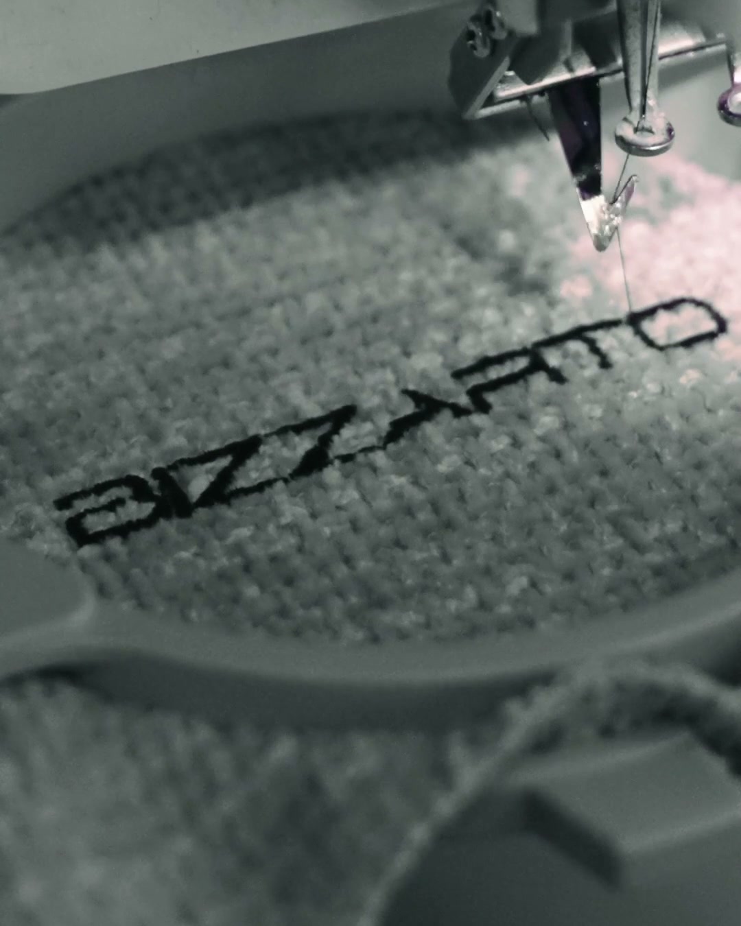 The Bizzarto logo being stitched into the fabric on a sewing machine, in our own manufactory